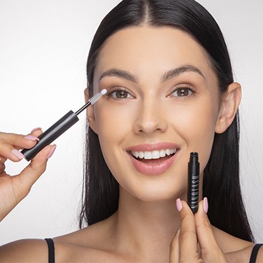 Smiling woman applying the sealer