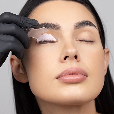 Model holds the Lash Lift glue with her fingers